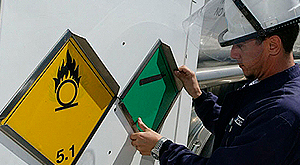 Operario colocando cartel de riesgo